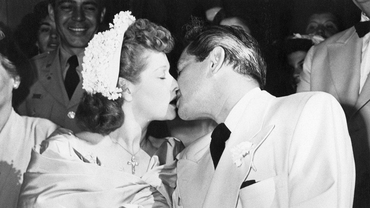 Lucille Ball and Desi Arnaz kissing on their wedding day