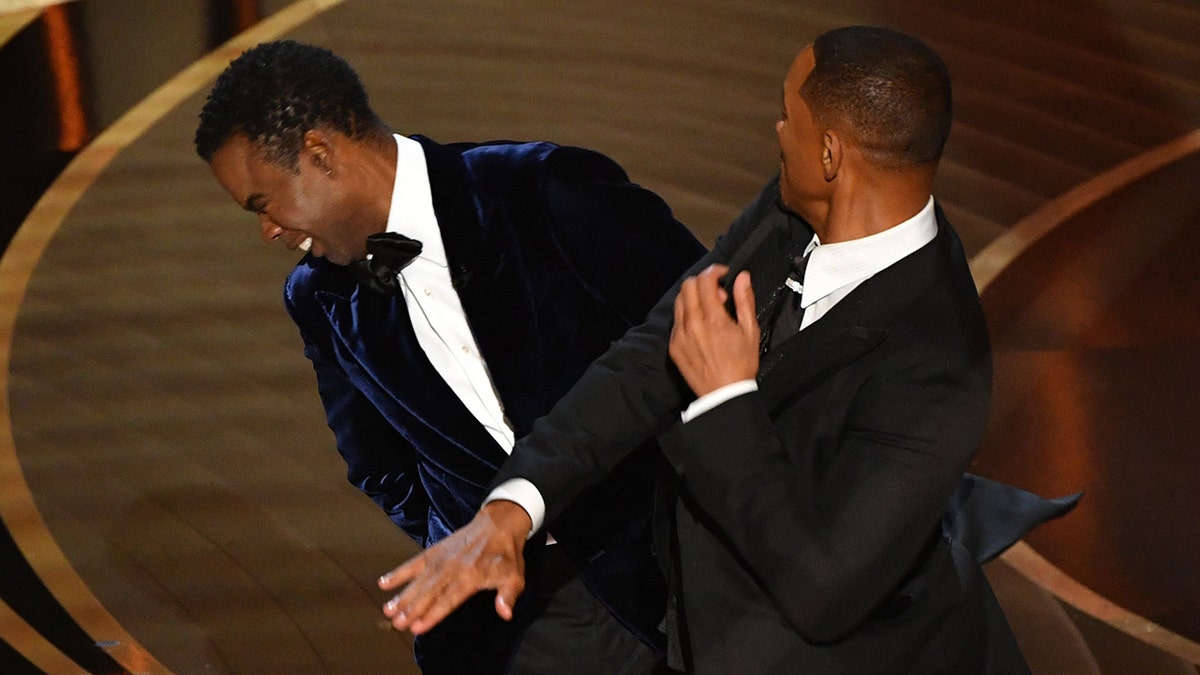 Will Smith slapping Chris Rock as they both wear tuxes