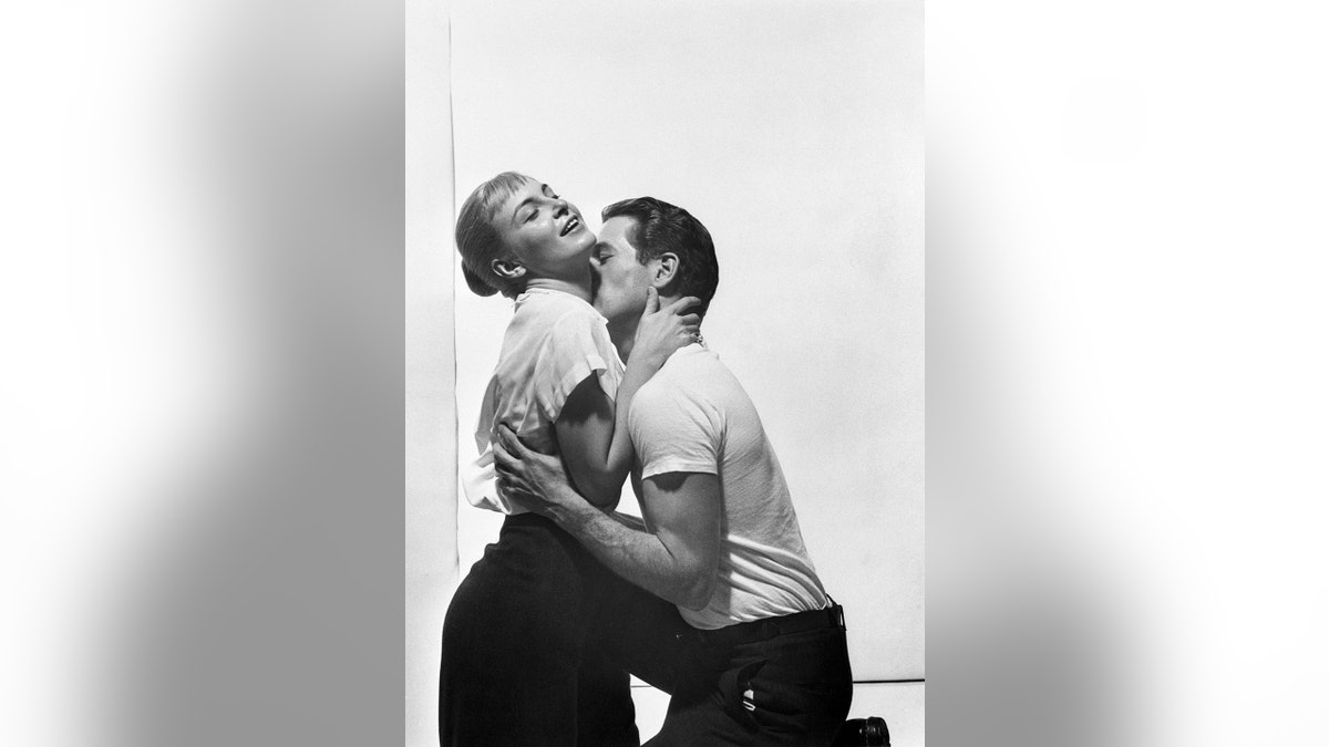 Paul Newman kissing Joanne Woodwards neck