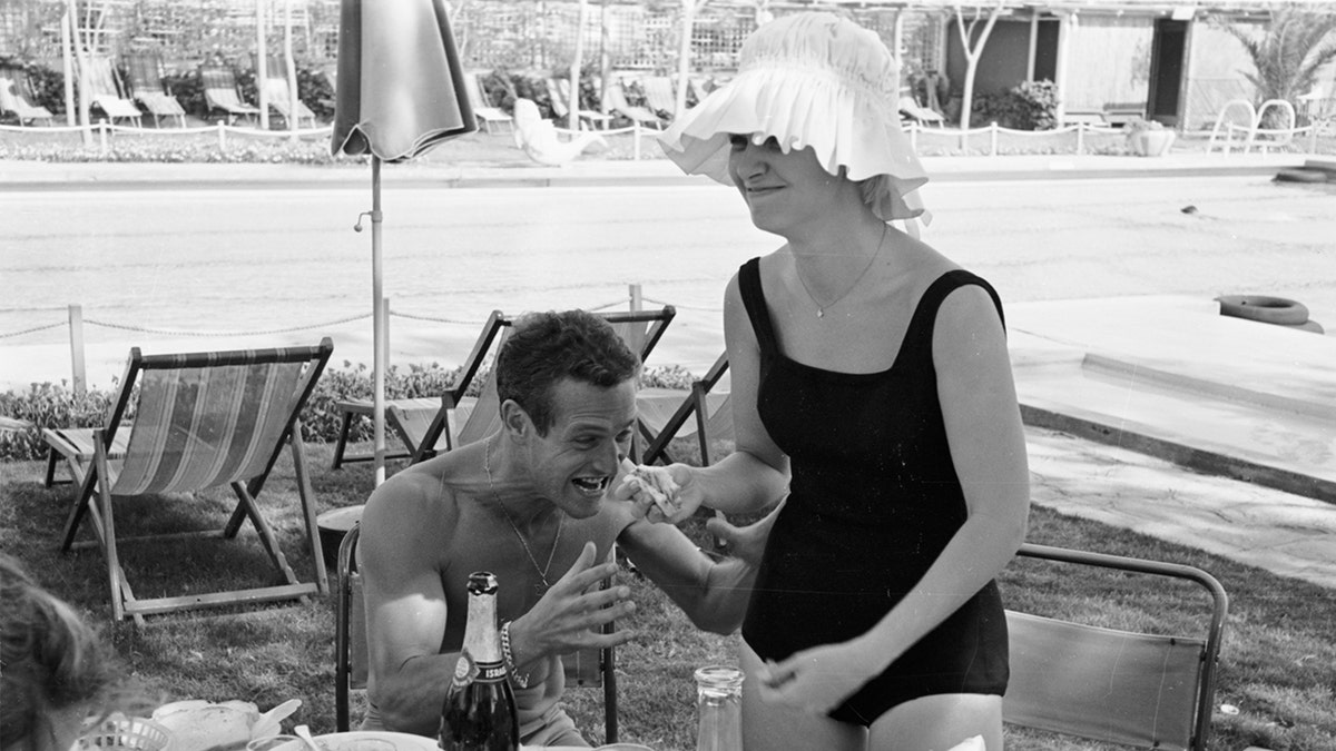 Actor Paul Newman goofing with wife, actress Joanne Woodward