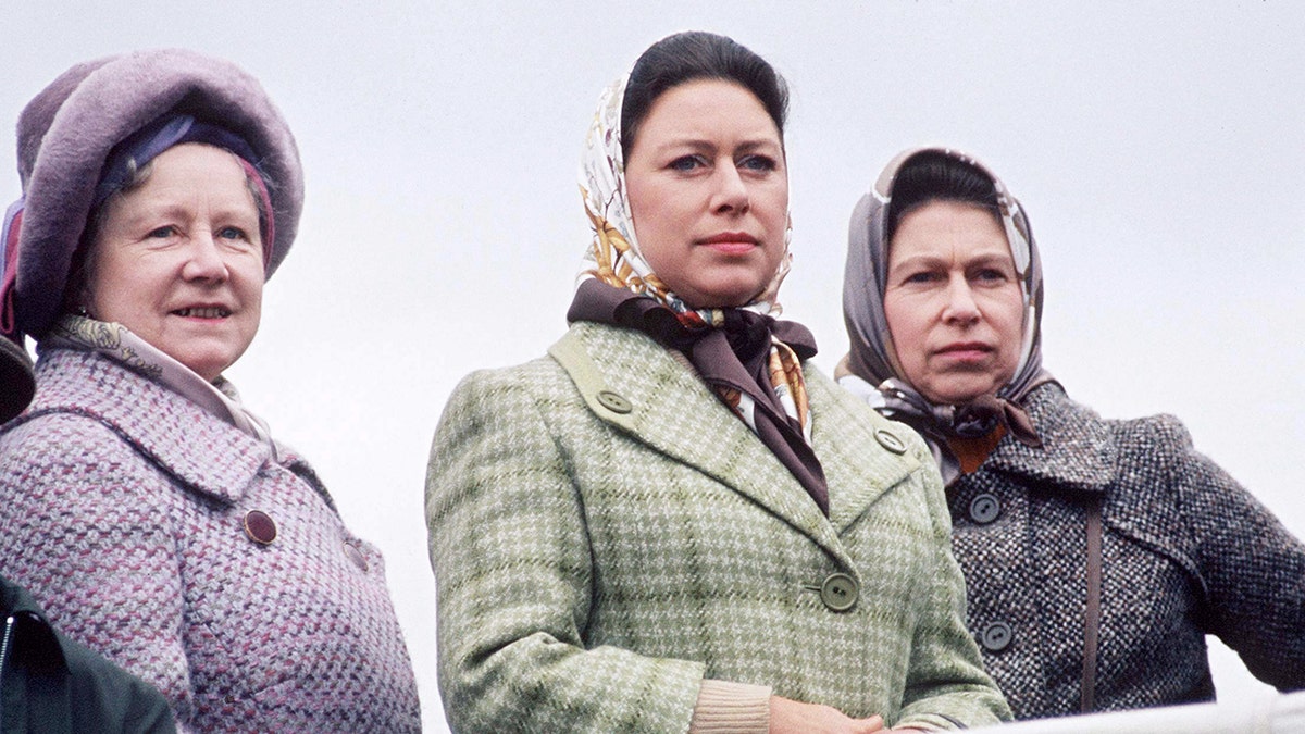 The Queen Mother, Princess Margaret and Queen Elizabeth all with their heads covered and wearing coats