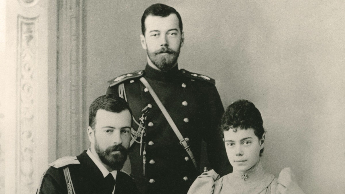 A portrait of the Romanovs looking serious in formal wear