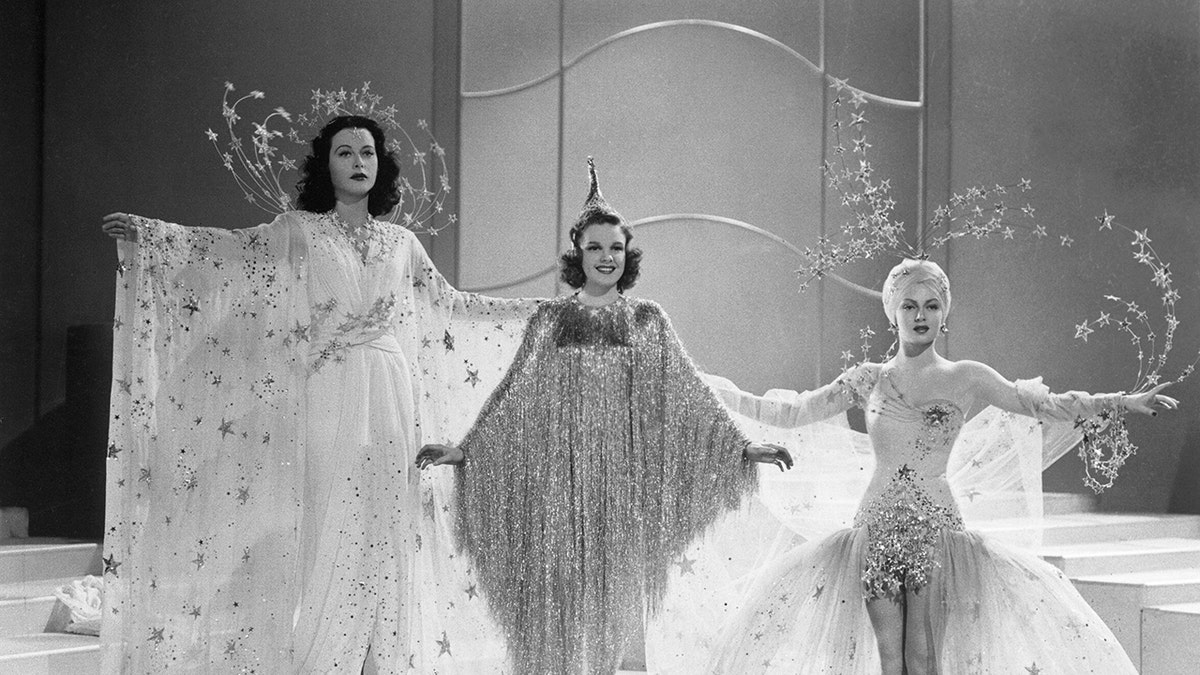 Judy Garland in a glamorous gown in the middle of Hedy Lamarr and Lana Turner
