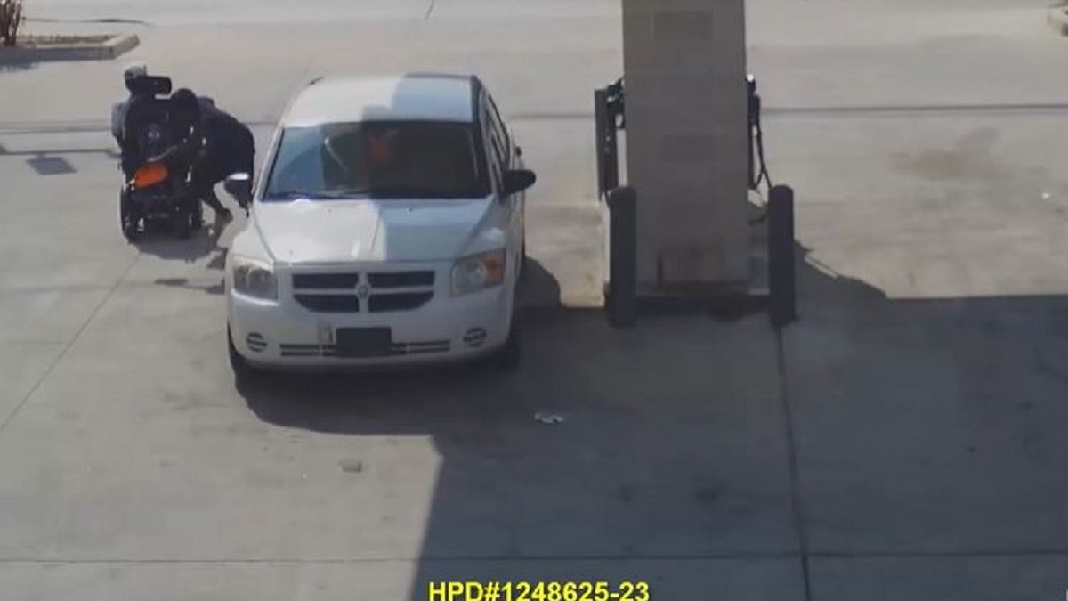 Video footage shows a thief snatching a bag from behind a man in a wheelchair and running off.