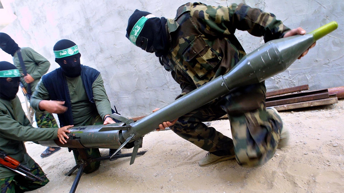 Hamas militants loading a rocket.