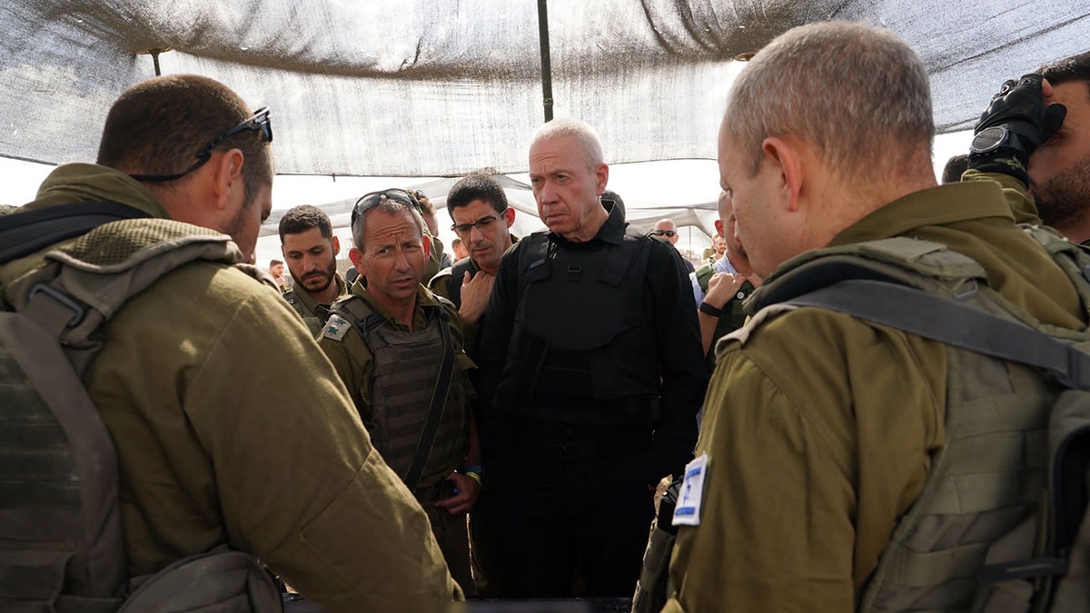 Israeli Defense Minister Yoav Gallant and Israeli soldiers