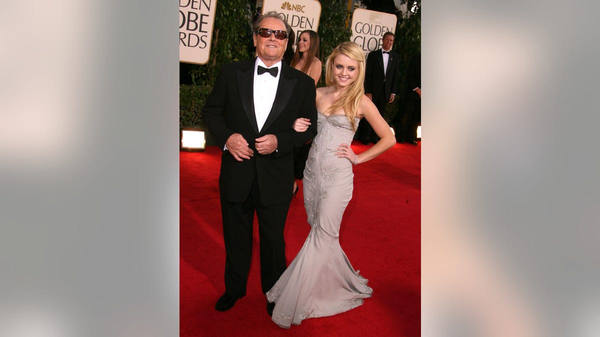 Jack Nicholson and Lorraine Nicholson posing together on the Golden Globes red carpet