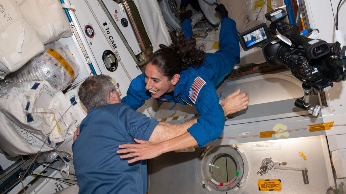NASA astronaut Jasmin Moghbeli gives her crewmate a hug 