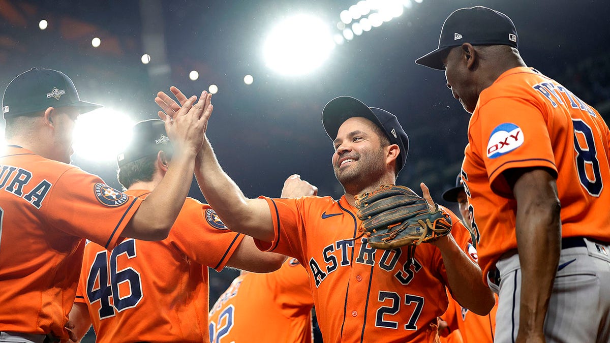 Jose Altuve #27 of the Houston Astros celebrates with his teammates after defeating the Texas Rangers in Game Five of the American League Championship Series at Globe Life Field on October 20, 2023 in Arlington, Texas.