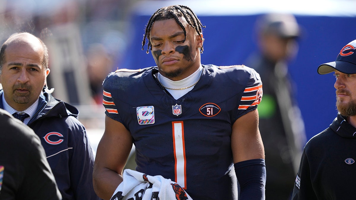 Chicago Bears quarterback Justin Fields comes off injured