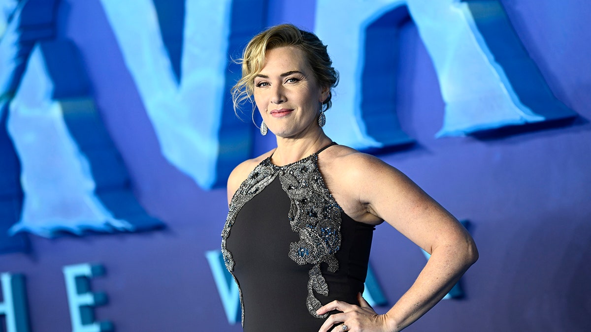 Kate Winslet posing with her hands on her hips