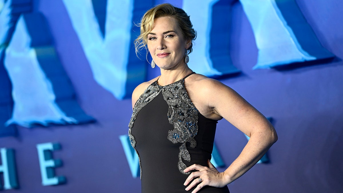 Kate Winslet posing with her hands on her hips