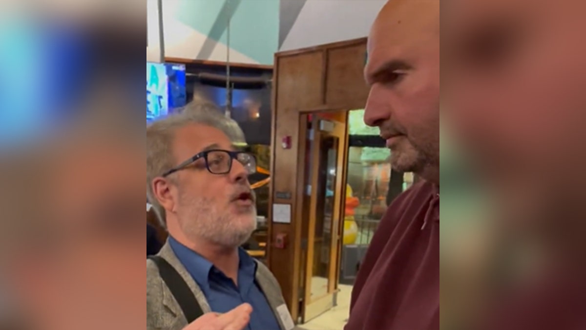 A man confronts Sen. John Fetterman in a restaurant