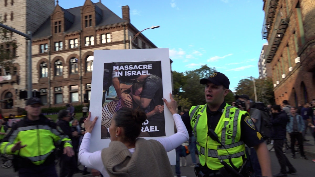 Counter protester with sign in Cambridge