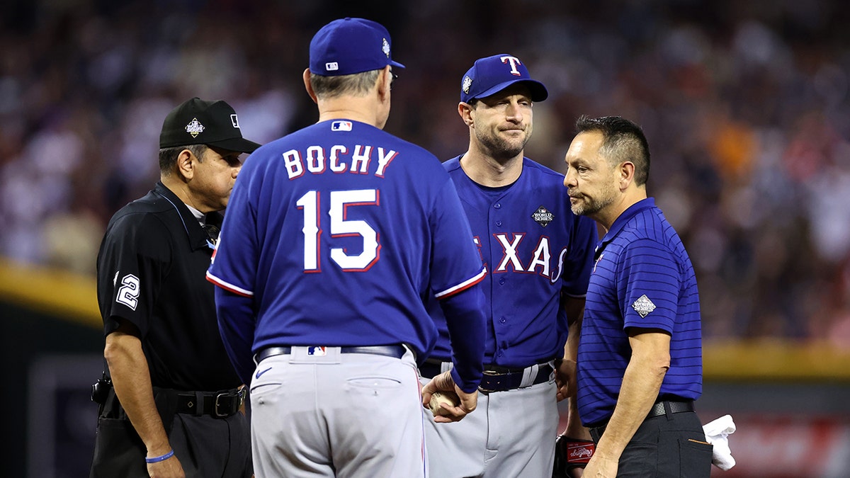 Rangers’ Max Scherzer exits World Series Game 3 start with apparent back injury 1 Max Scherzer speaks with coaches and trainers