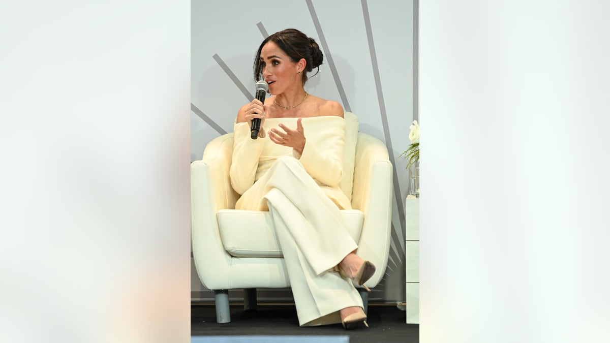 Meghan Markle talks into a mic
