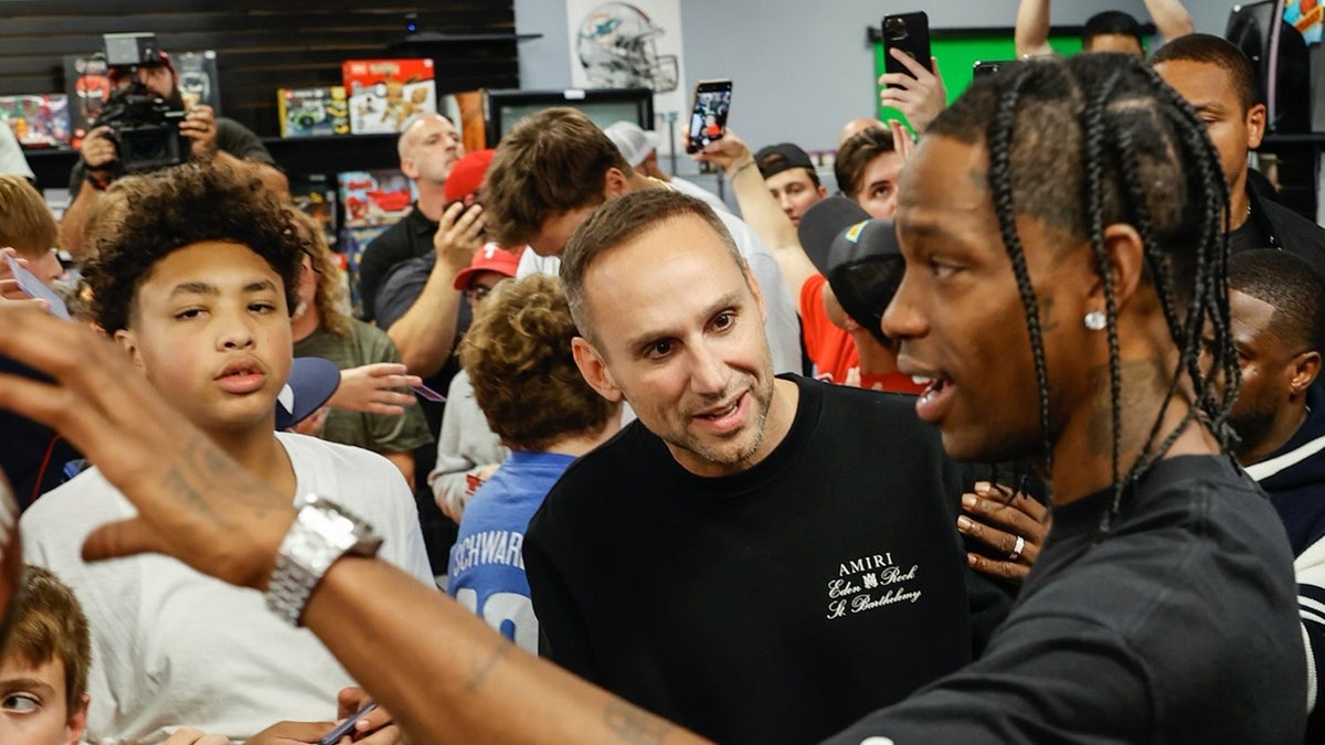 Michael Rubin and Travis Scott interact with kids