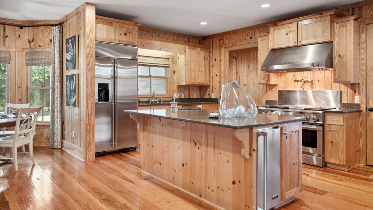 Pine floors and cabinets and stainless steel appliances in the Murdaugh kitchen.