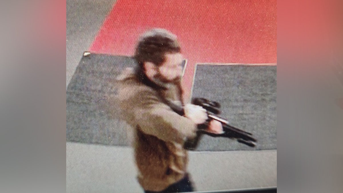 Suspect seen in picture holding a gun