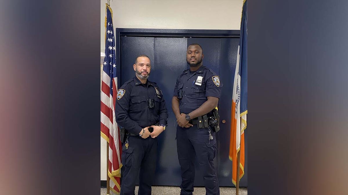 Officers Fayette and Mata pose in Precinct building