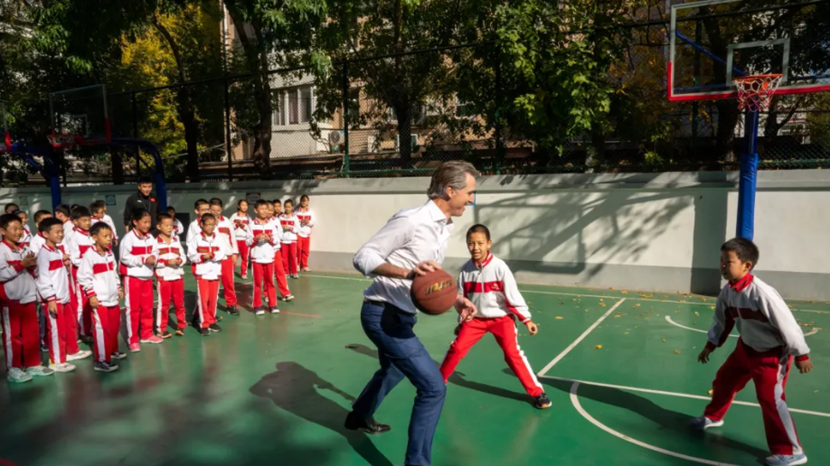 Gavin Newsom playing basketball in China
