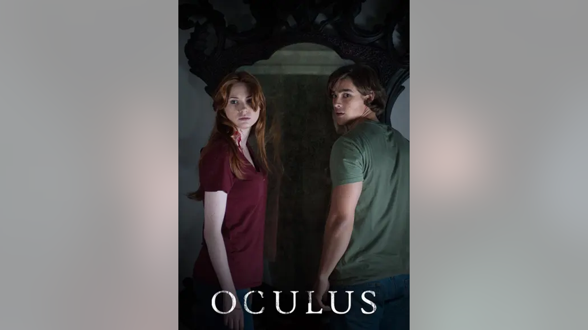"Oculus" movie poster with girl and boy staring at camera