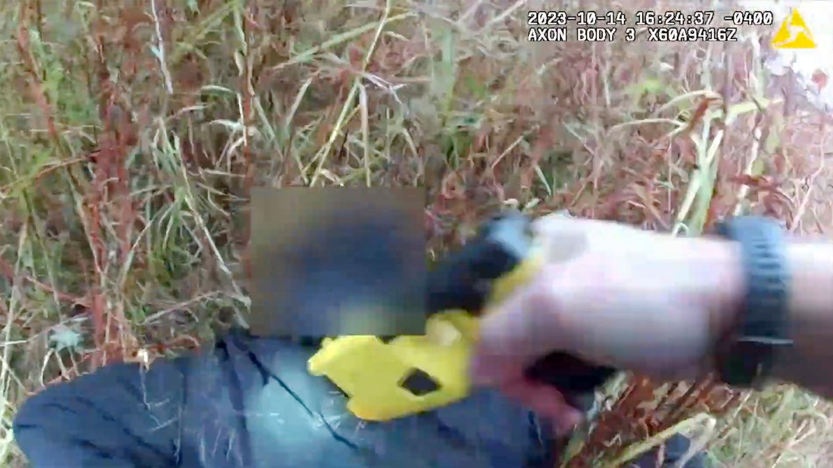 Officer Nicholas Kehoss pulls a stun gun trigger 