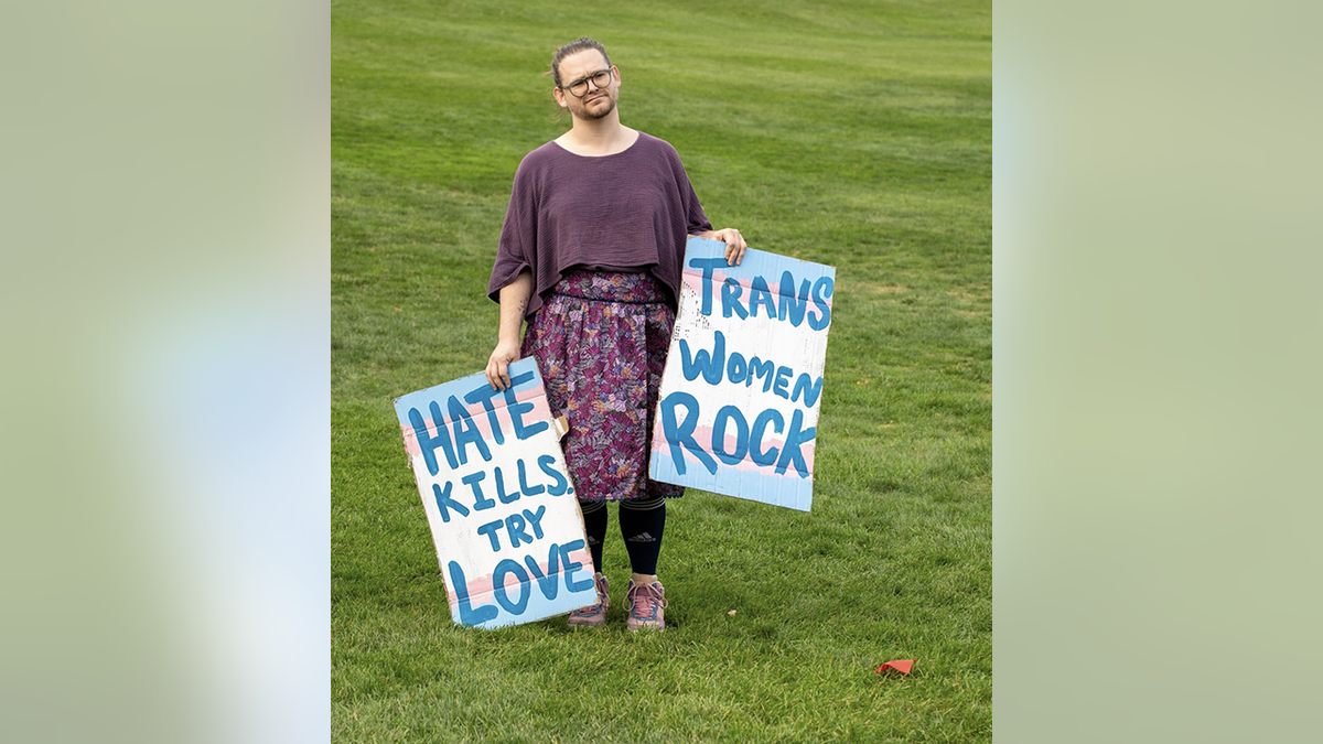 A protester holds signs