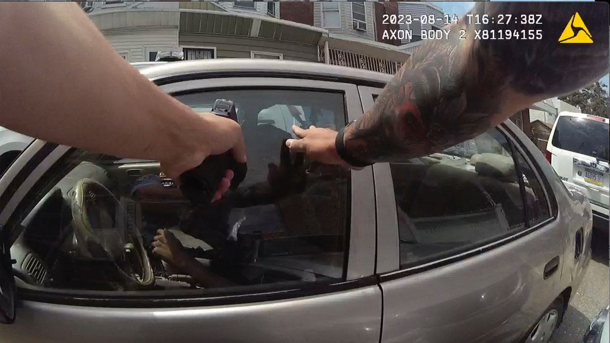 Screen grab from police body cam video showing police officer with his weapon drawn