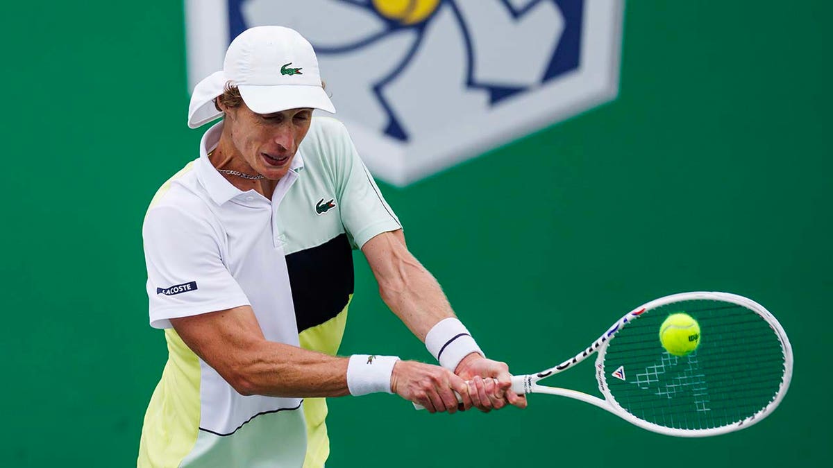 Marc Polmans hits a backhand