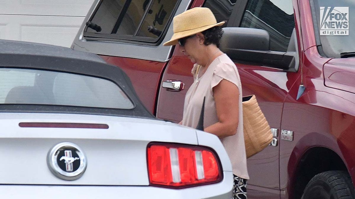 Roberta Laundrie walks to her car outside of her Florida home.