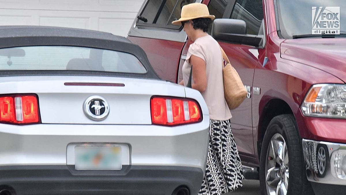 Roberta Laundrie walks to her car outside of her Florida home.