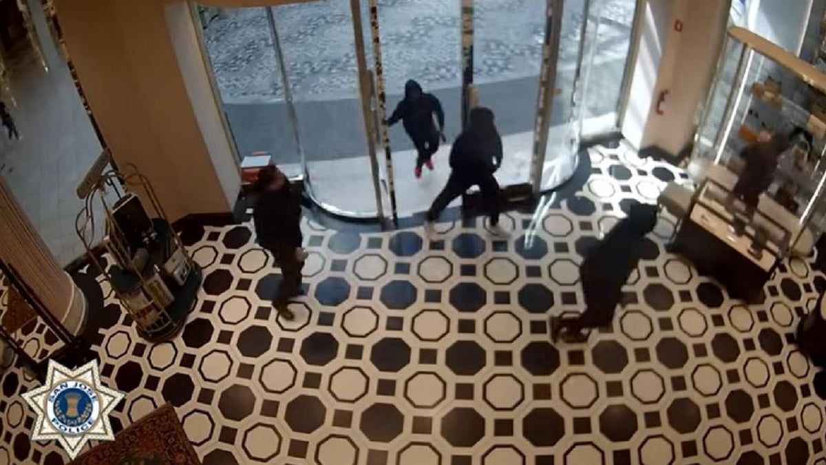 Security video shows masked thieves running past a Gucci store security guard during a robbery