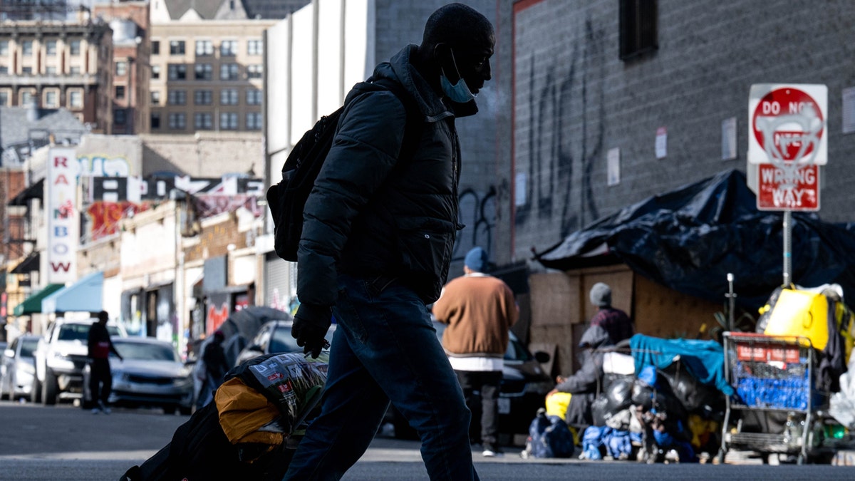 homeless man walks on street