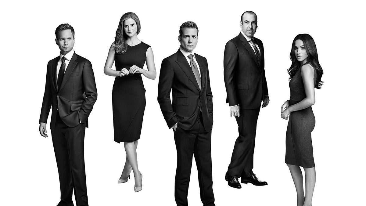 Black and white photo of the cast of Suits, including Meghan Markle, far right