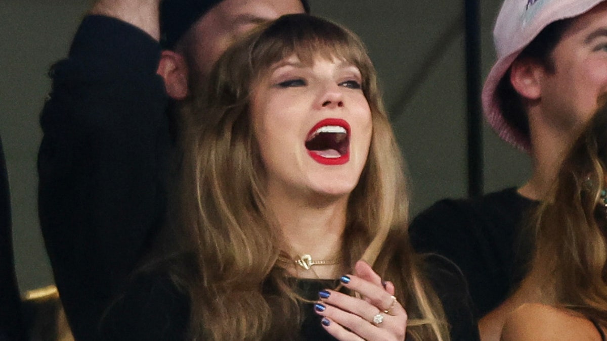 Taylor Swift cheers at NFL game