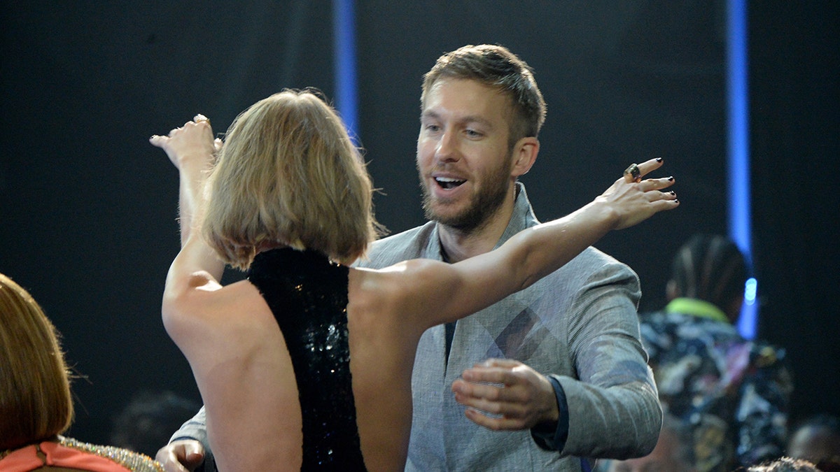 Taylor Swift going for a hug with Calvin Harris