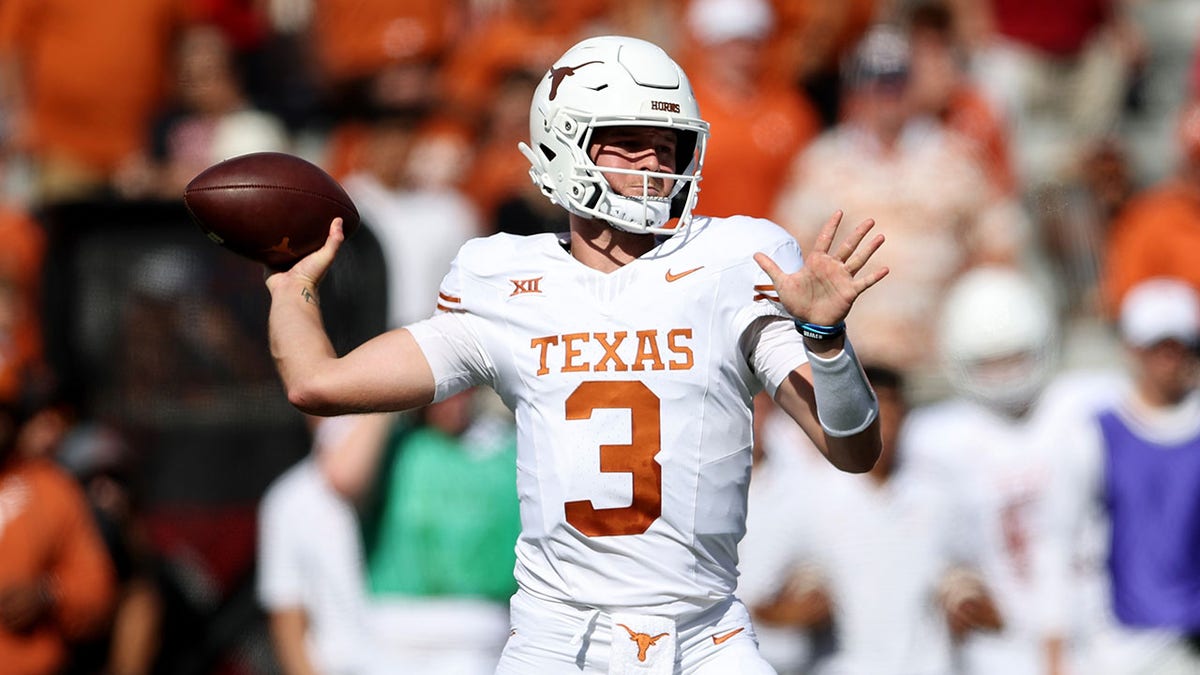 Quinn Ewers throws a pass