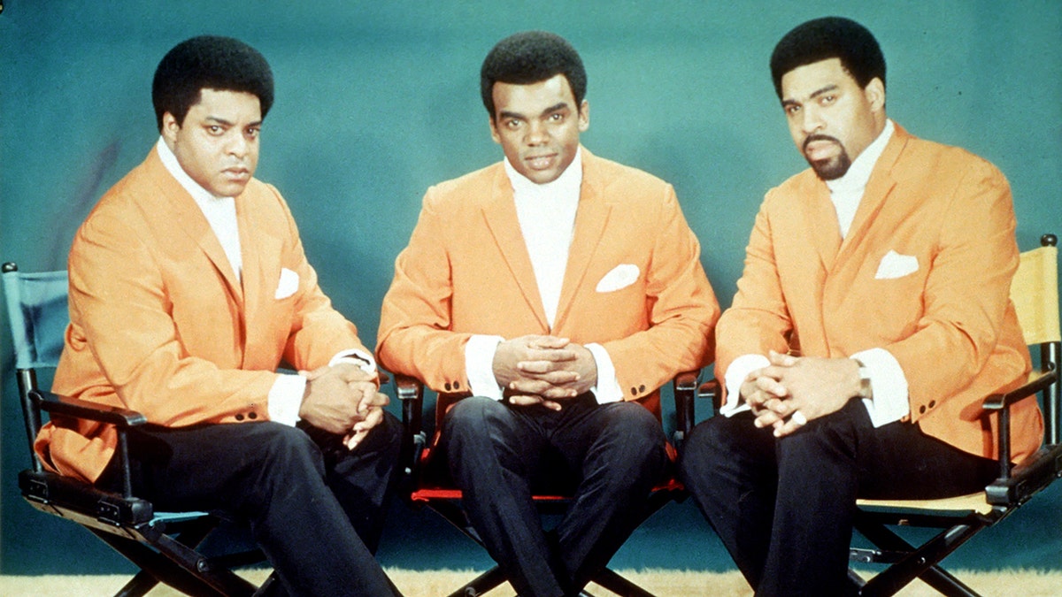 The Isley Brothers sitting in chairs