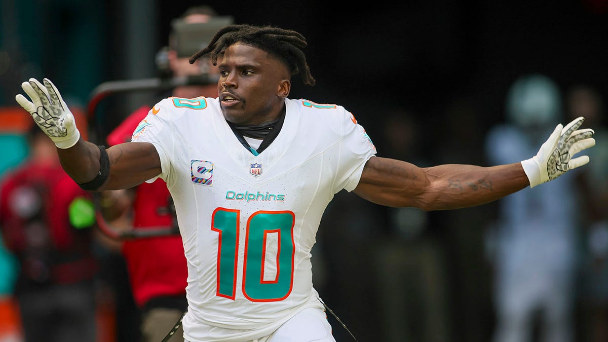Tyreek Hill surprises fan with signed Dolphins gear after viral touchdown  ball mix-up
