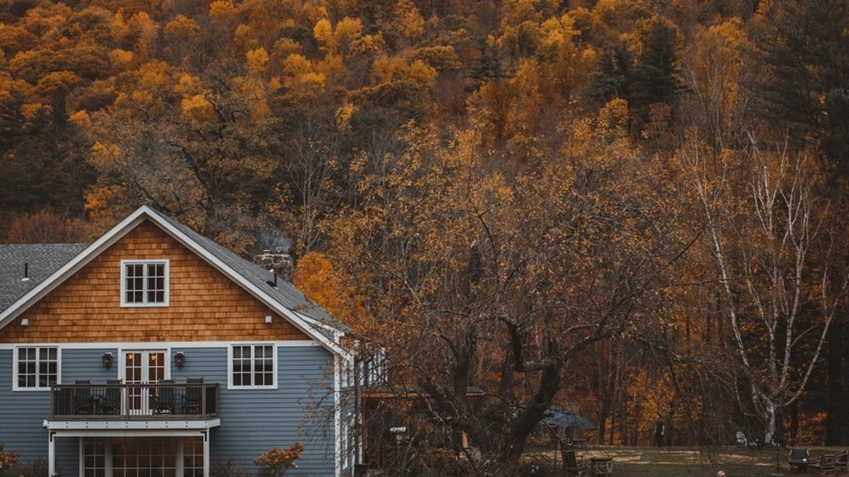 house surrounded by fall foliage