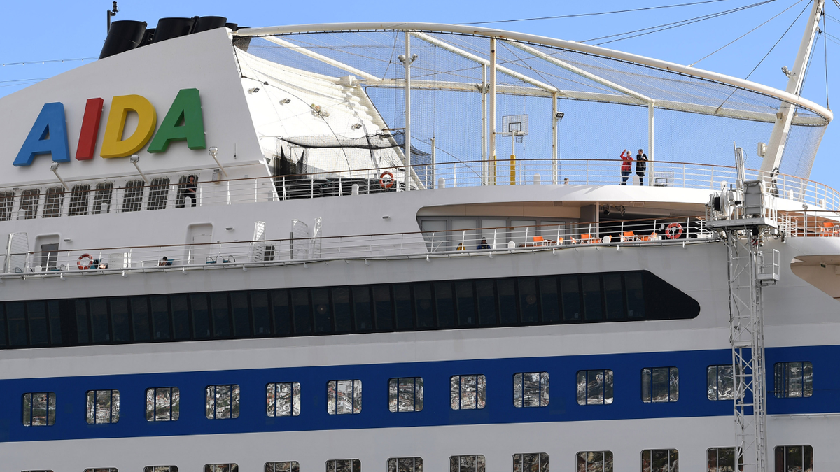 AIDA Cruise ship passengers seen at the top of the ship.