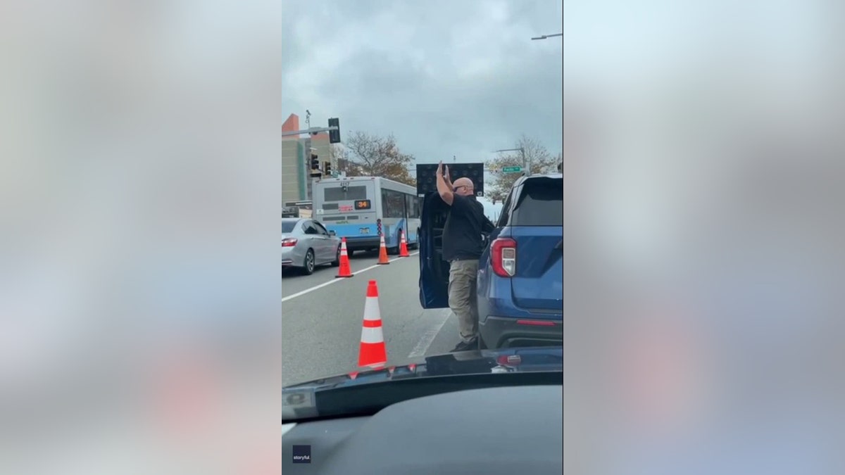 suv driver putting hands in the air
