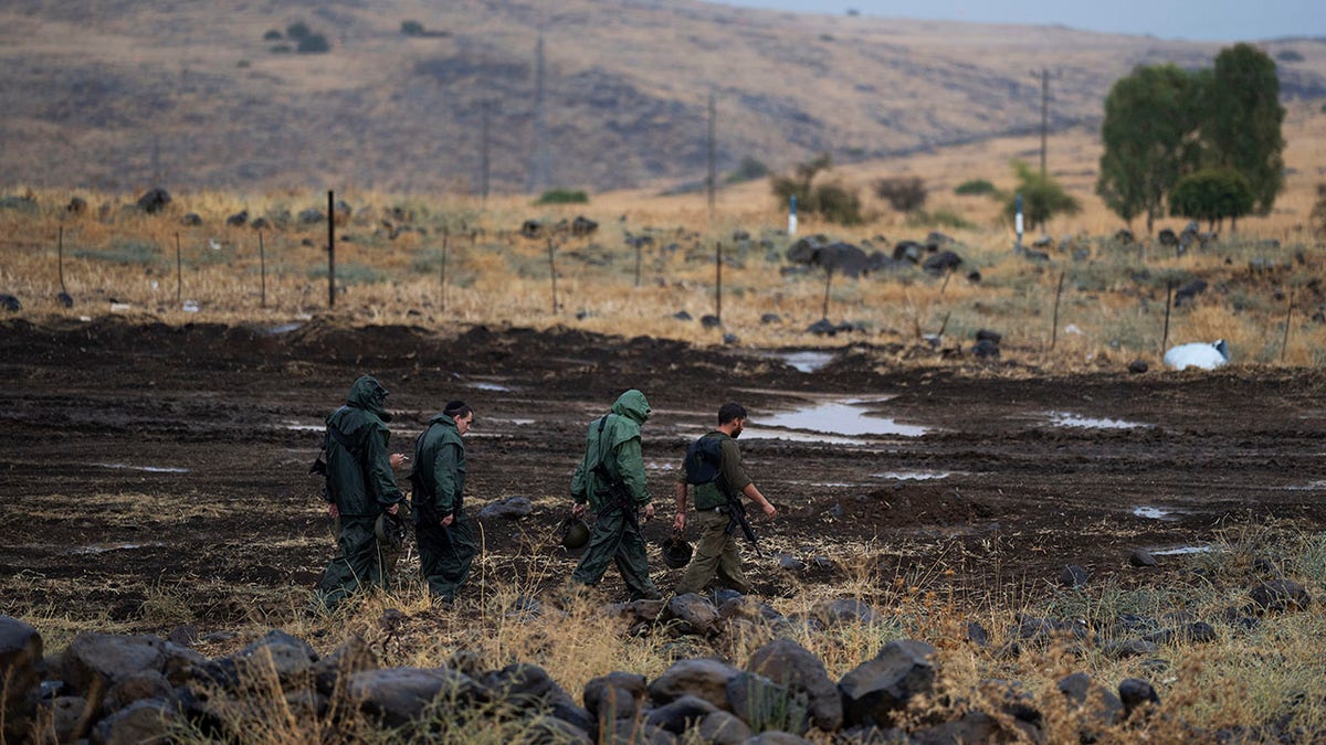 Israeli soldiers walk near Lebanon border