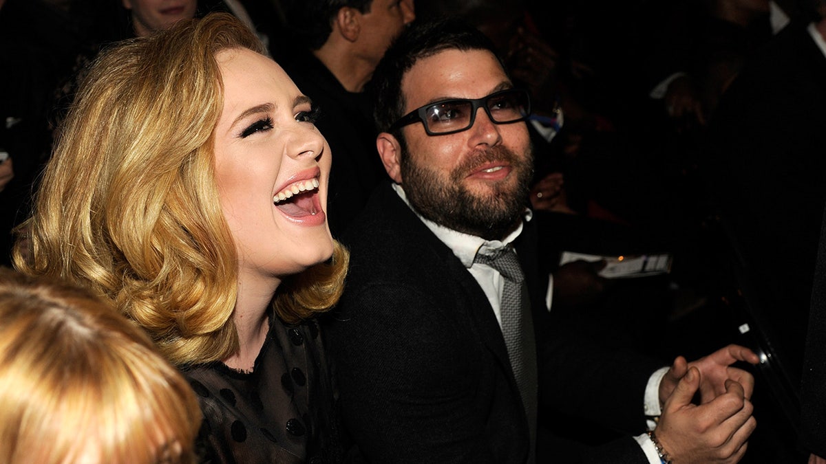 Adele laughing with Simon Konecki in 2012