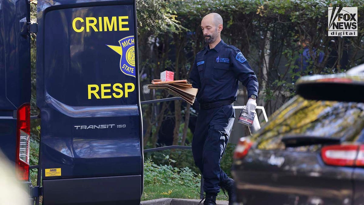 Michigan State Police Crime Scenes Unit compile evidence outside of Samantha Woll's home
