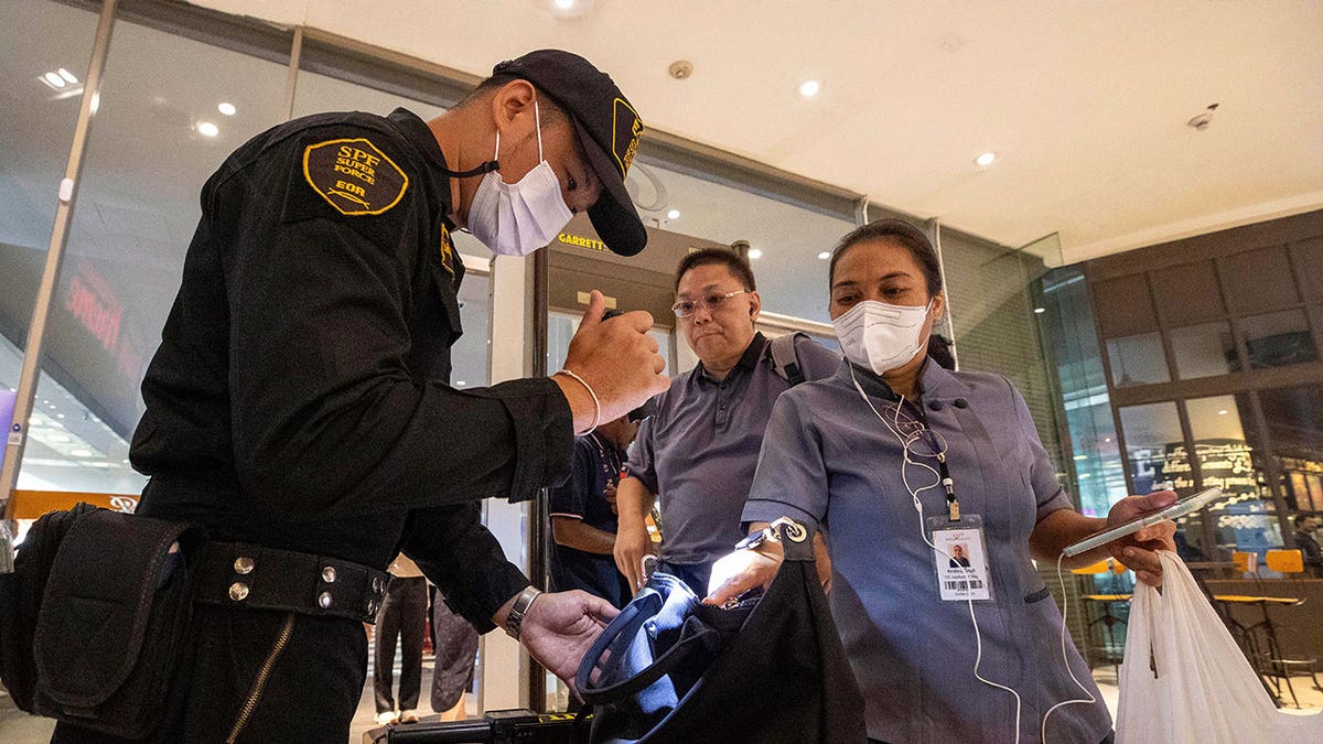 guard checks bag