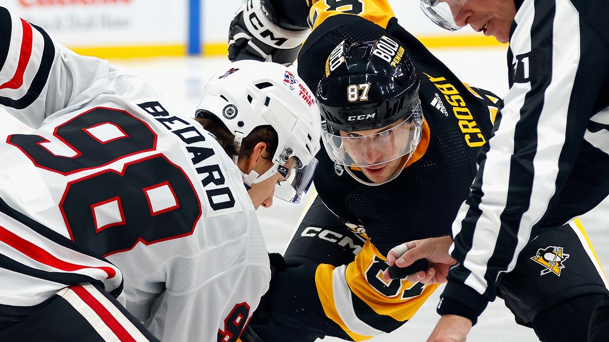 Connor Bedard and Sidney Crosby face off