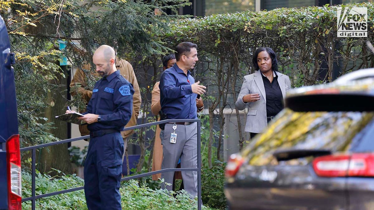 Michigan State Police Crime Scenes Unit compile evidence outside of Samantha Woll's home