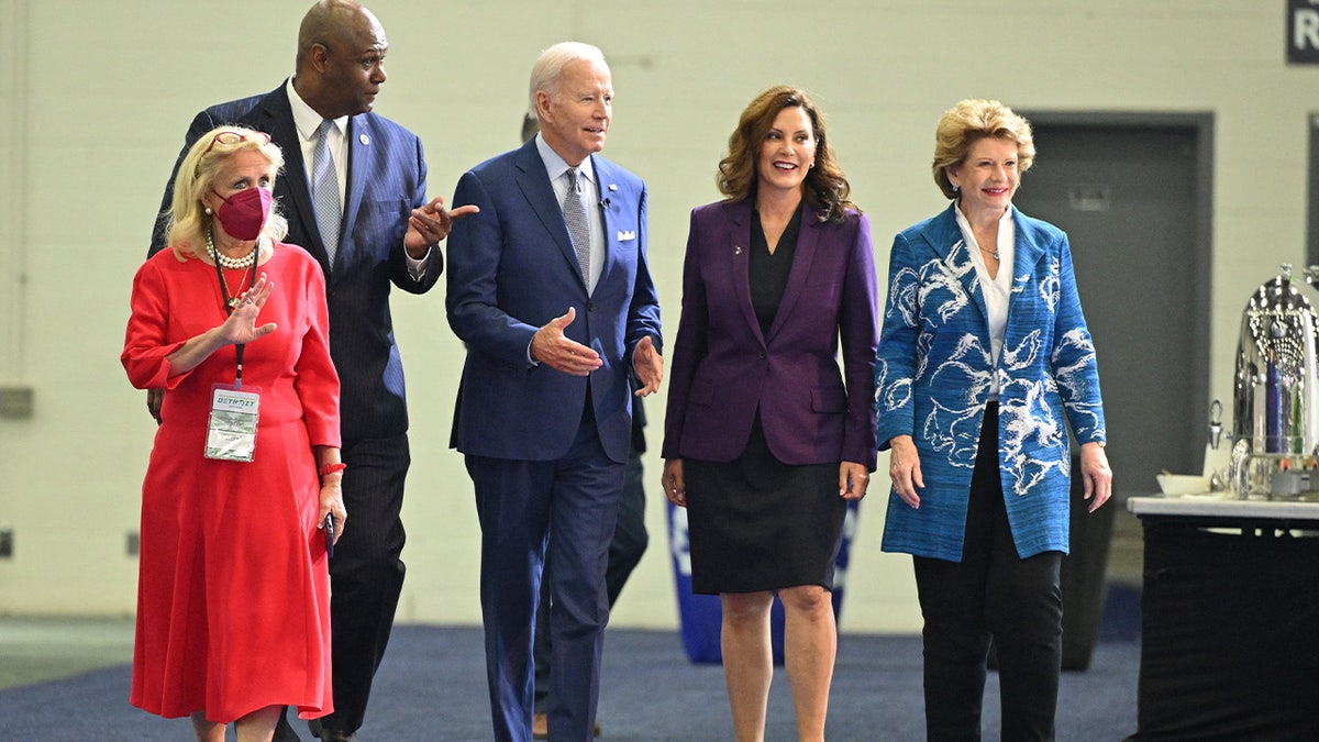 President Joe Biden, Michigan Governor Gretchen Whitmer and US Senator Debbie Stabenow, arrive to tour the 2022 North American International Auto Show in Detroit, Michigan, on September 14, 2022. - Biden is visiting the auto show to highlight electric vehicle manufacturing.